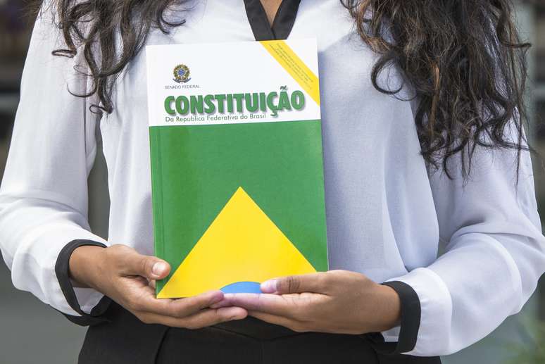 Florianópolis, Santa Catarina, Brazil - April 21, 2018: A close-up view of a woman holding the Constitution of the Federative Republic of Brazil book in Santa Catarina state, Brazil