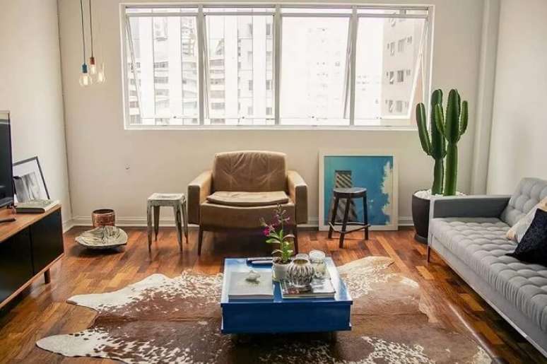 9. A sala de estar moderna tem um vaso de cacto grande perto da janela, assim a planta pode tomar sol. Fonte &ndash; Casa Aberta