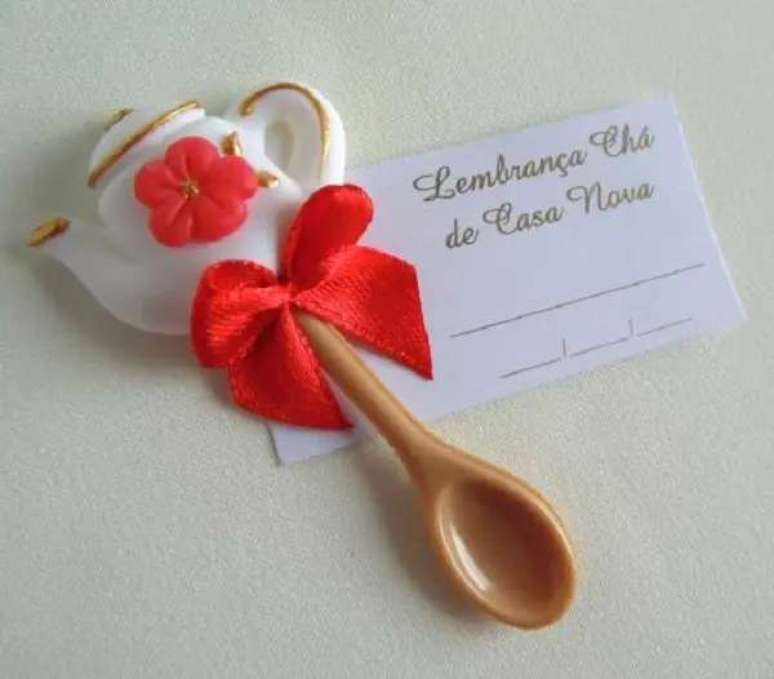 60- A lembrancinha de ch&aacute; de casa nova tem bule e colher de resina. Fonte: Festas.Site
