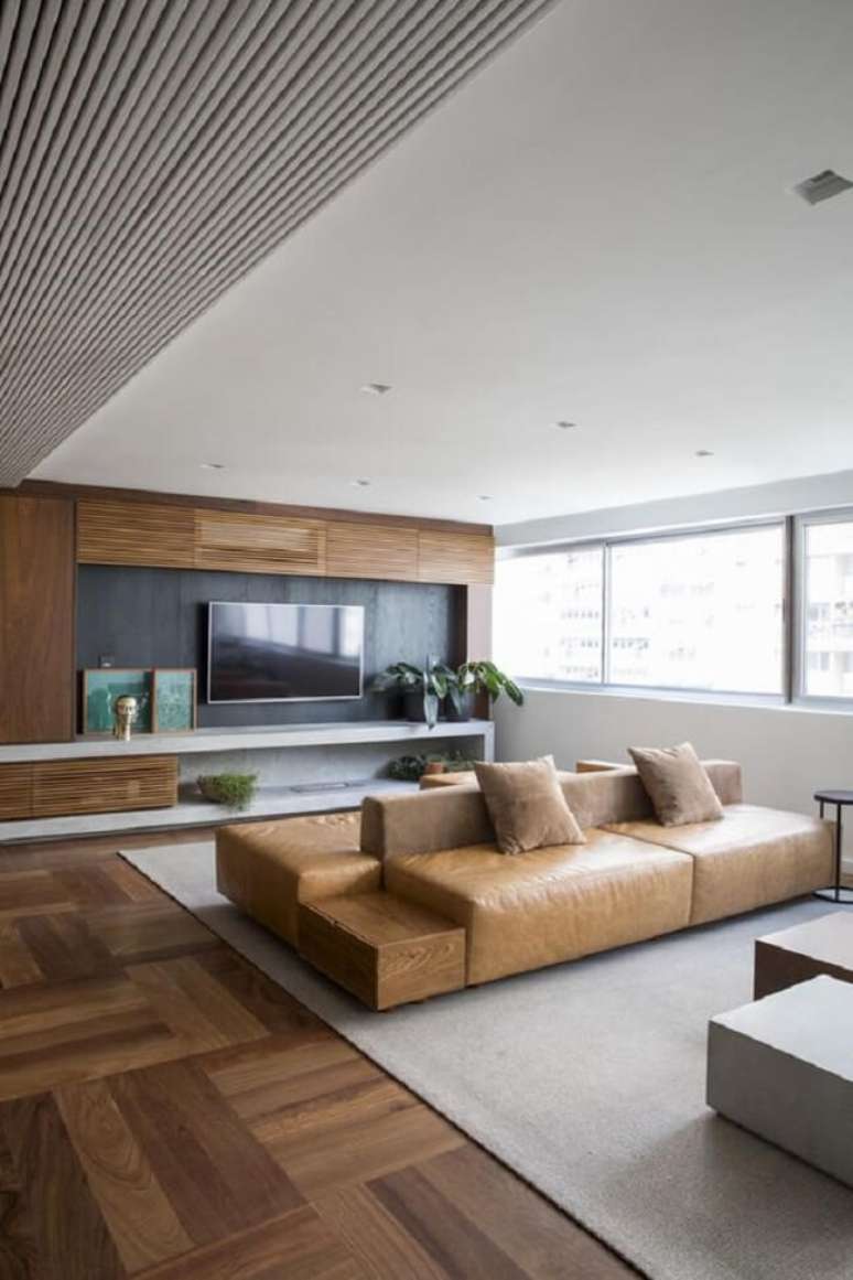 28. Projeto de sala sofisticada com sof&aacute;-ilha. Fonte &ndash; Meireles Pavan Arquitetura