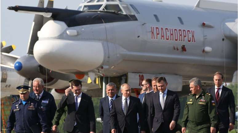 Um Tupolev Tu-95 BEAR, como o que foi atingido na base de Engels. Na foto, tirada em maio, Vladimir Putin e outras autoridades visitam a maior fábrica dessas aeronaves