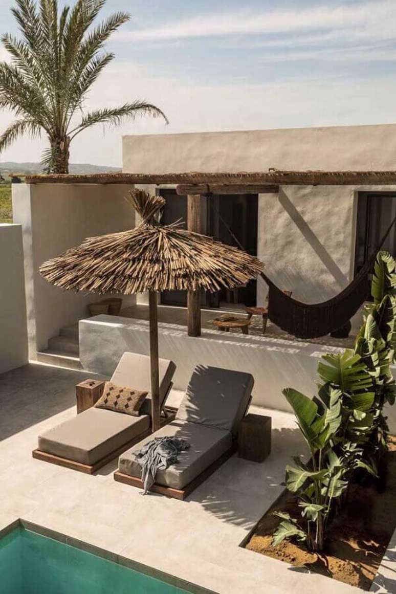 29. Decora&ccedil;&atilde;o com guarda sol rustico e espregui&ccedil;adeira de madeira para piscina &ndash; Foto: Behance