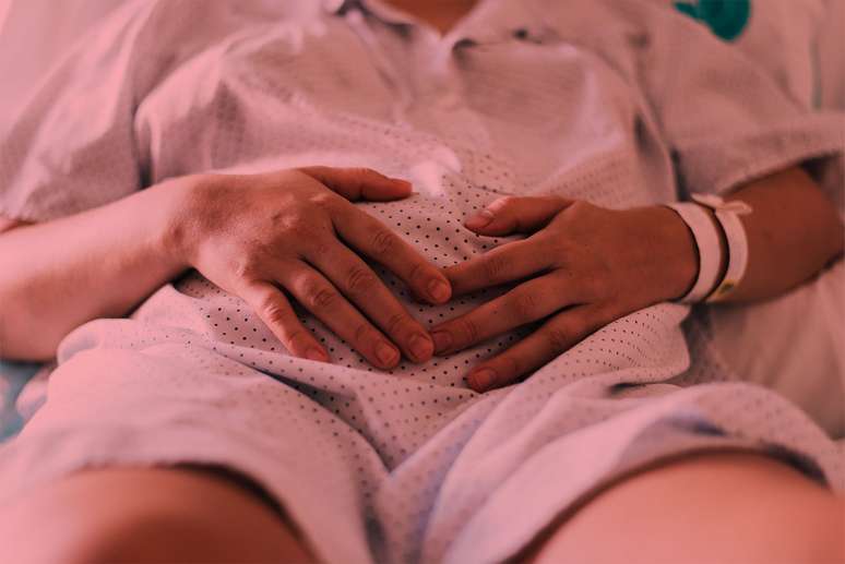 Woman in hospital holding her belly