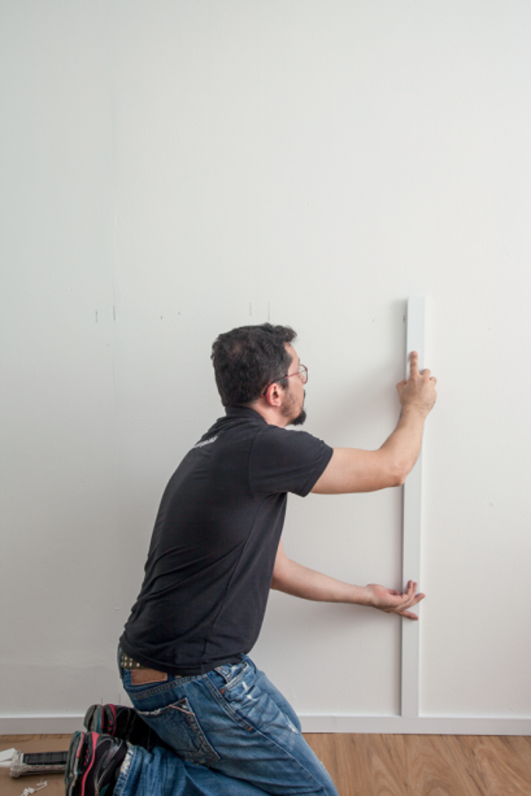 Make sure the fillets are the same height (these are 1.18m) - this will ensure a perfectly aligned design.  All right, let's start the installation: apply glue to the back of the piece and fix it within the limits of your mark on the wall.  Press and hold for a few seconds to lock it.