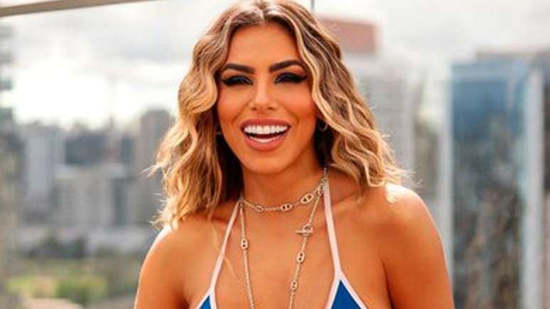 Erika Schneider flaunts six pack abs and tanned body in orange mini look