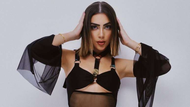 Jade Picon wears a very skintight dress and flaunts a contoured body