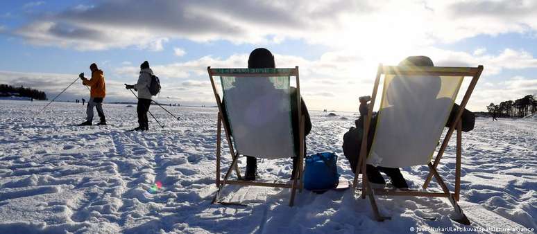 Os finlandeses apreciam sentar-se ao sol em plena neve no mês de fevereiro em Helsinque