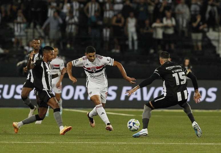 Michel Araujo tenta passar por marcadores do Botafogo neste sábado (Foto: Rubens Chiri/São Paulo FC)