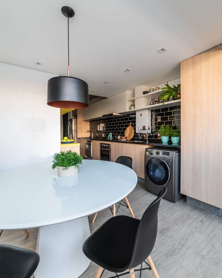 The black backsplash complements the lighter palette, made up of wood tones.  Project: Studio Guadix
