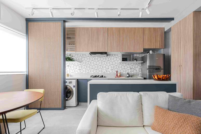 Muxarabi panel separates the kitchen and laundry from the social area in this project by Studio Moby Dick.