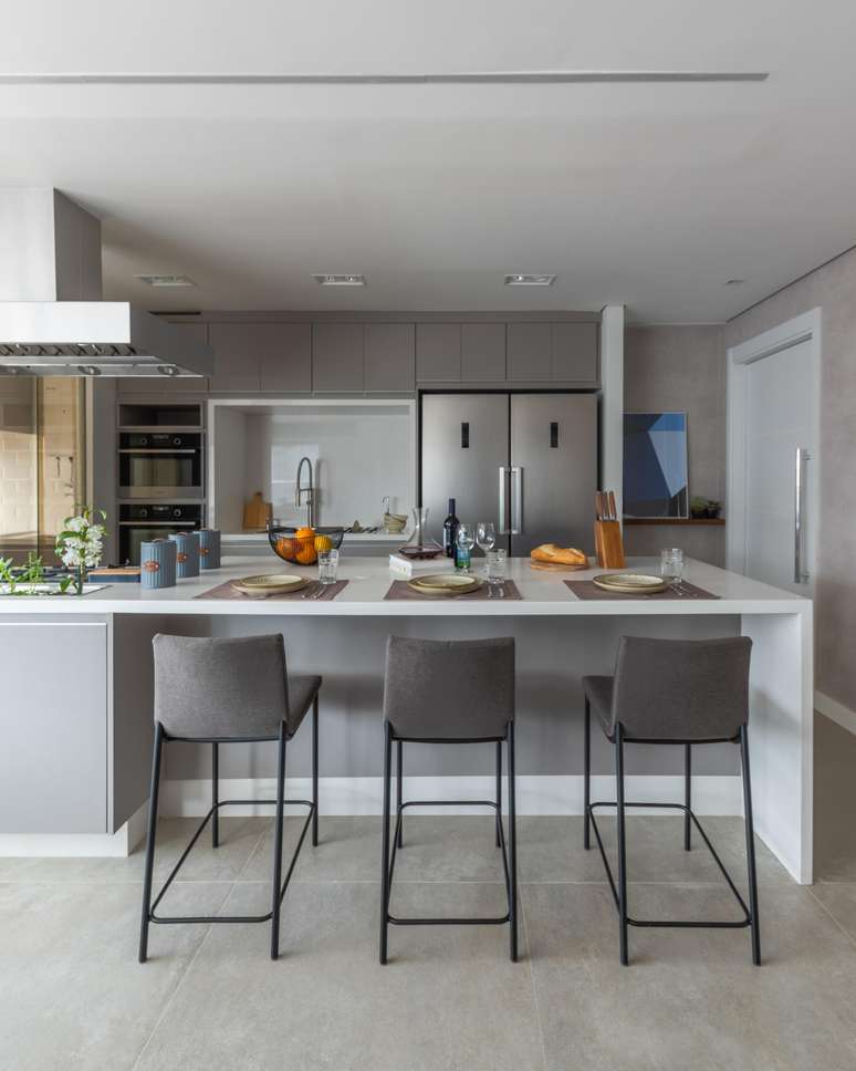 Bruno shows much appreciation for this project.  The harmonious colors of the floor, the joinery and the stools make the environment visually harmonious.  To generate a contrast, the white quartz on the countertops works very well, as well as the feet of the stools in black.