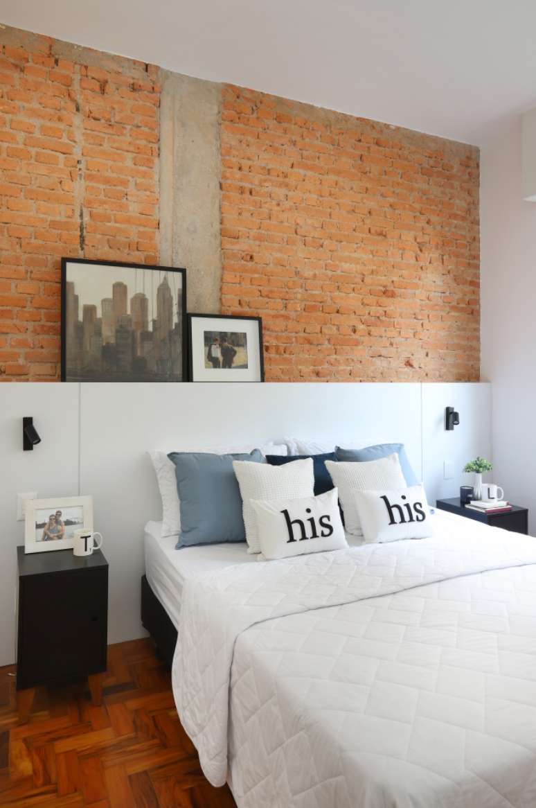 Bedroom with bedside wall covered in natural colored bricks.