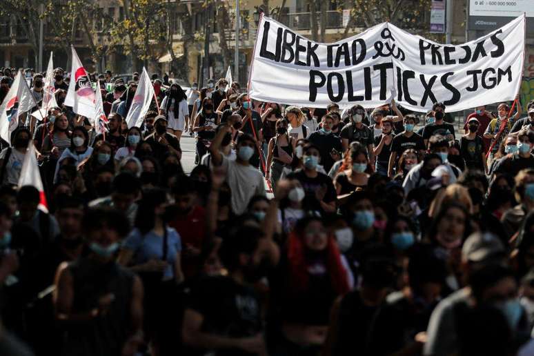 Manifestantes seguram cartaz com linguagem neutra em protesto no Chile