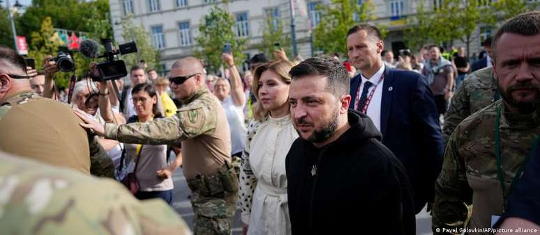 Acompanhado da mulher, Olena, o presidente ucraniano Volodimir Zelenski é escoltado por seguranças ao chegar em Vilnius, na Lituânia, para a cúpula da Otan.