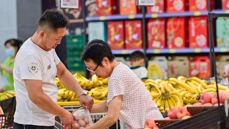 Homem e mulher fazendo compras em supermercado na China