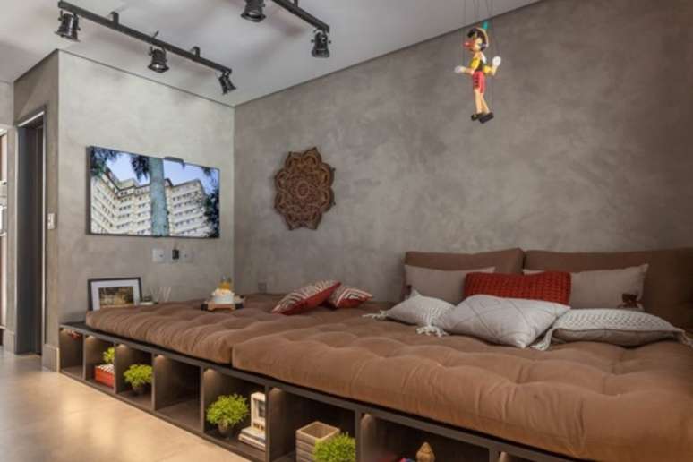 The decision to include a futon in the living room instead of the traditional sofa was made to create a more relaxed atmosphere and accommodate more people. 