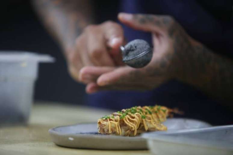 Com kimchi de pupunha, maionese picante e cebolinha, Dário Costa finaliza o camarão mole. FOTO ALEX SILVA/ESTADAO