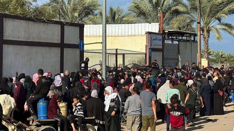 Centenas de pessoas fazem fila para obter gás de cozinha na cidade de Deir al-Balah, no centro de Gaza