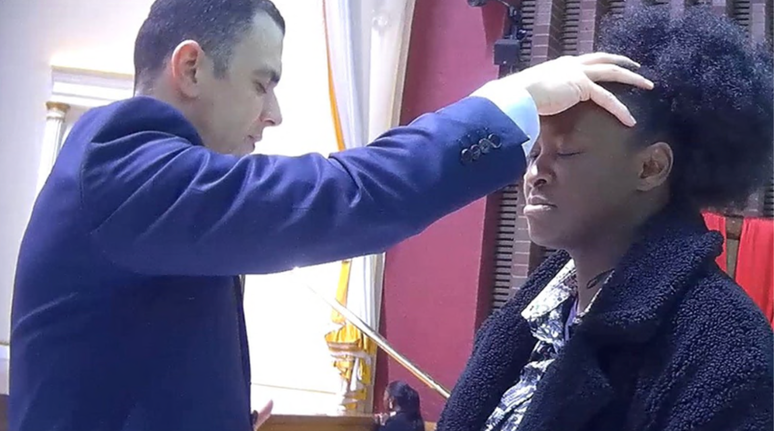 A rep&oacute;rter da BBC Katie Mark participando de um culto da IURD com o Pastor Miguel Conte