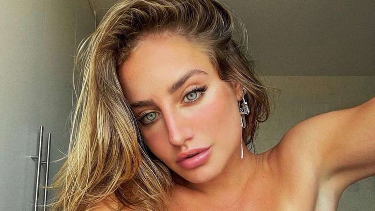 Bruna Griphao shows off her toned body in a white microskirt and top