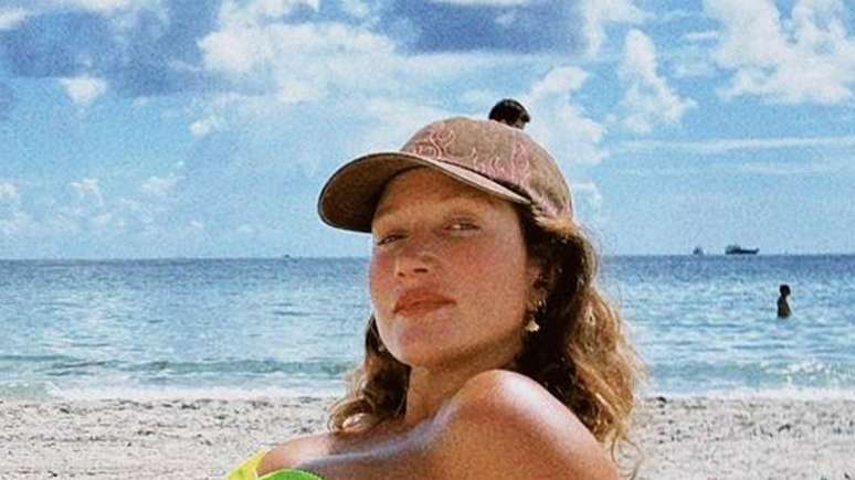 Gabriela Pugliesi for the web showing her baby bump in a half-naked shot in a heavenly setting