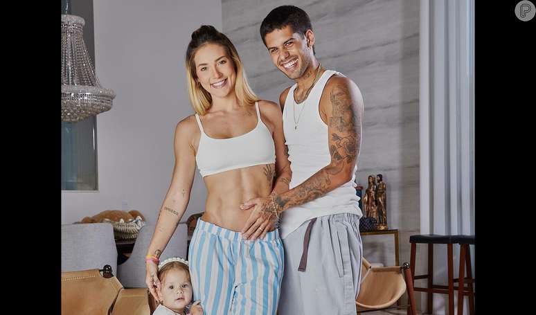 Virginia Fonseca, pregnant with her third child, shows her protruding belly in the bathroom in a photo