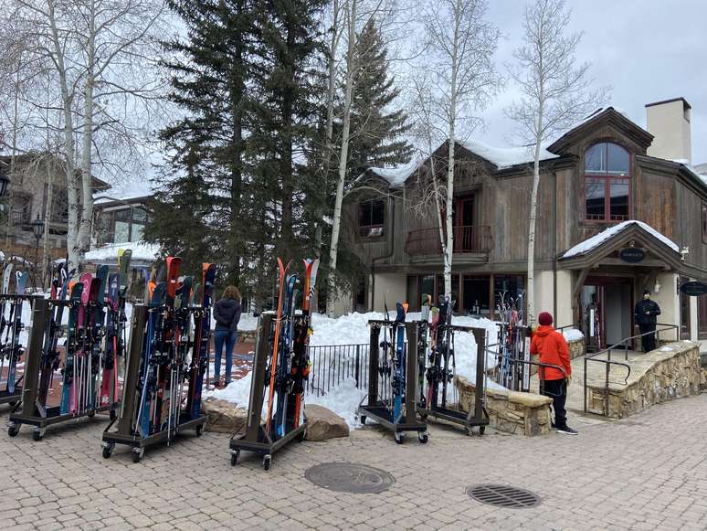 Esquis e bastões à espera dos hóspedes em frente à base do Four Seasons em Vail Village