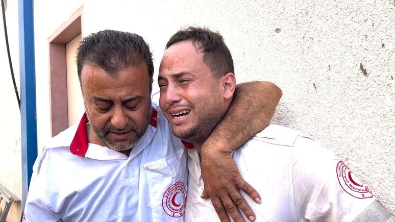 Mahmoud (à direita) foi consolado por um colega após descobrir que seu pai havia sido morto