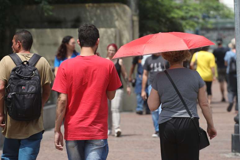 Pedestres sob forte sol e calor no Centro de São Paulo, SP