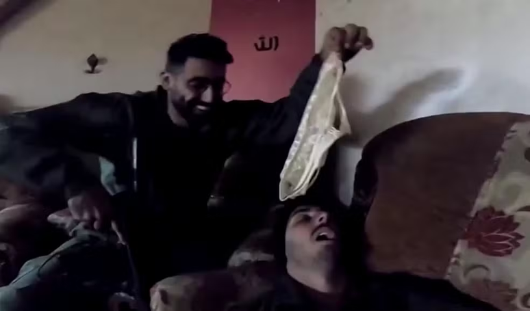 Em um dos registros, soldados levantam uma calcinha perto do rosto de um colega que finge dormir em um sofá