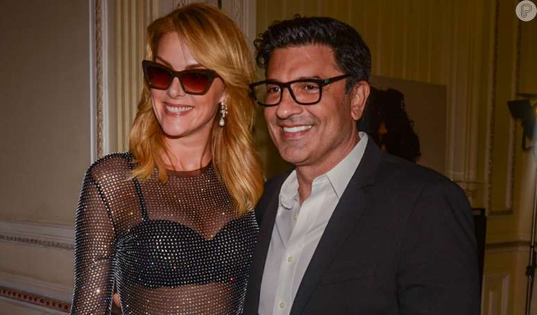 Ana Hickmann leaves her bra on display in a see-through look and gets a kiss from Edu Guedes at an event.  Photos!