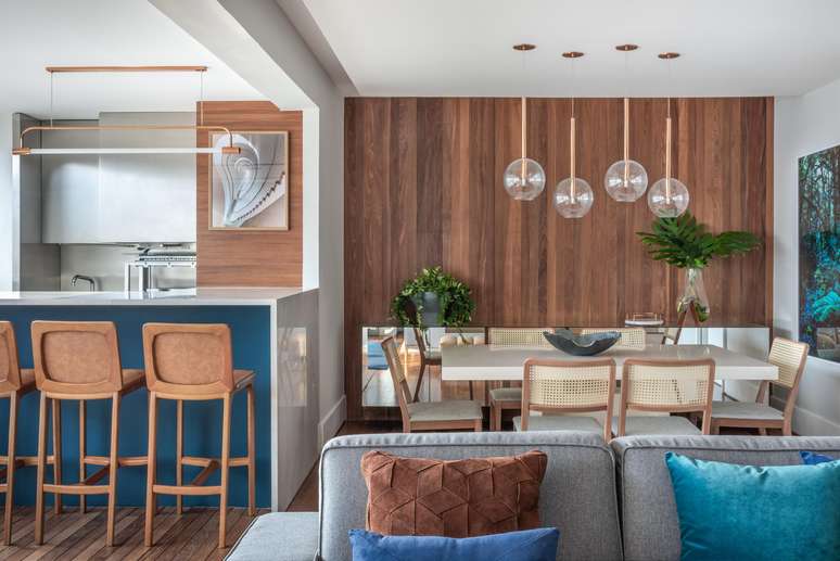 The apartment is decorated in blue, gray and wood tones