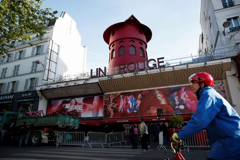 The windmill blades of the iconic Moulin Rouge cabaret in Paris collapse