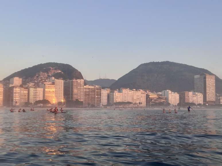 The golden light of dawn bathes the buildings of Copacabana