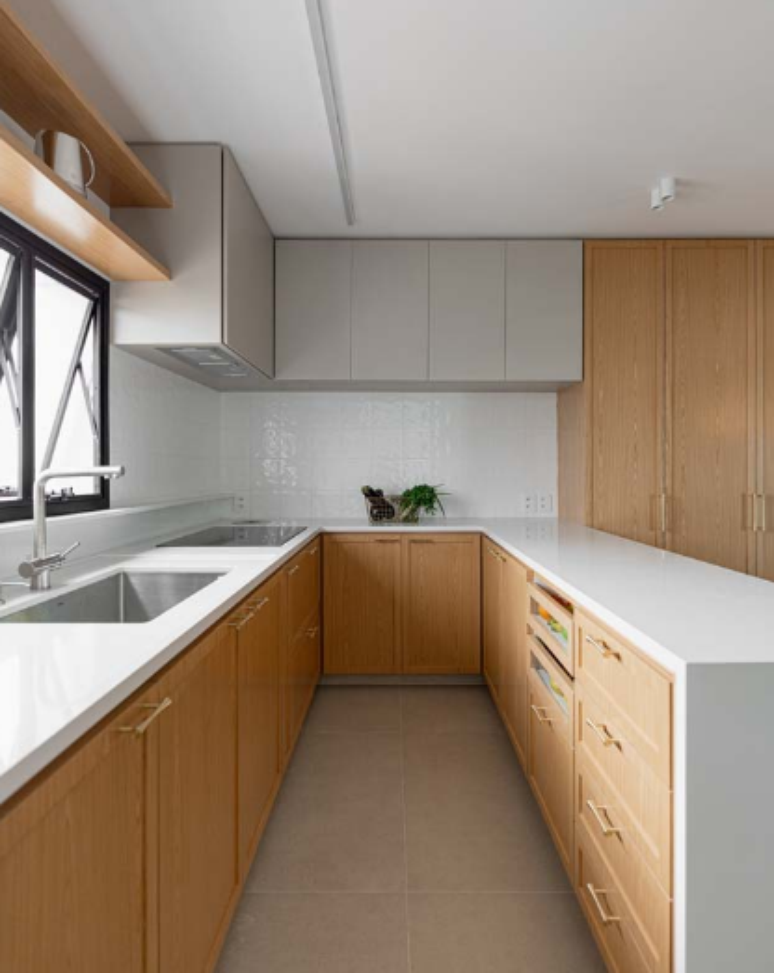 2. Cozinha planejada com bancada em U conta com mais espaço para armazenar itens – Projeto: Fenda Arquitetura | Foto: João Paulo Prado