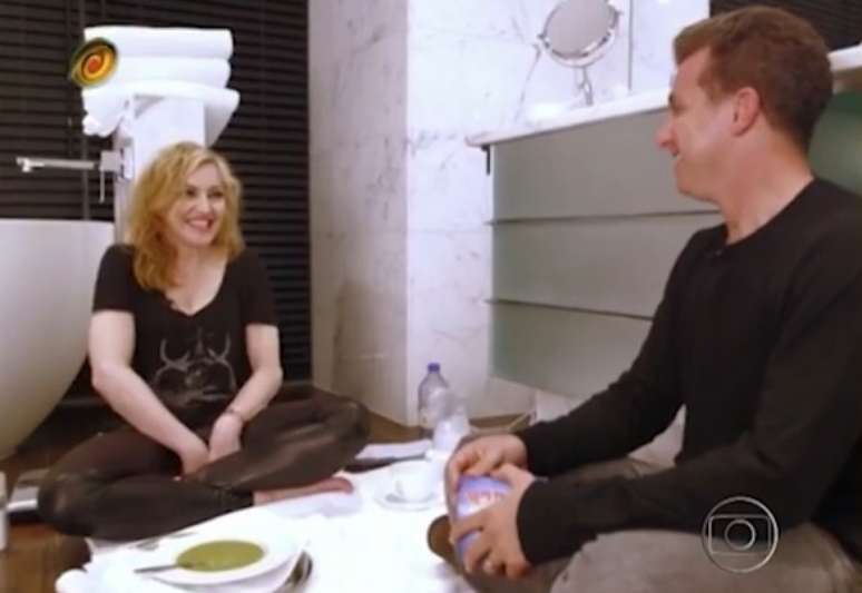 Na cama com Madonna? Não. Luciano Huck gravou a entrevista com os dois sentados no chão de um banheiro de hotel