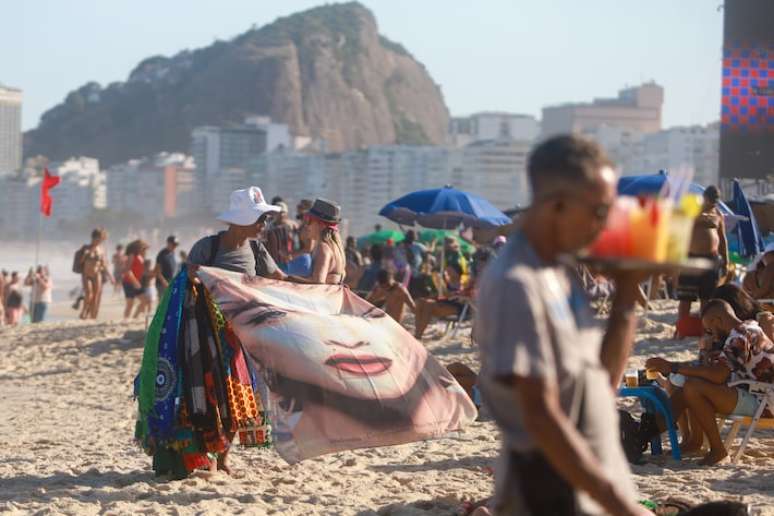Na calçada ou na areia, vendedores oferecem mercadorias variadas com o rosto de Madonna