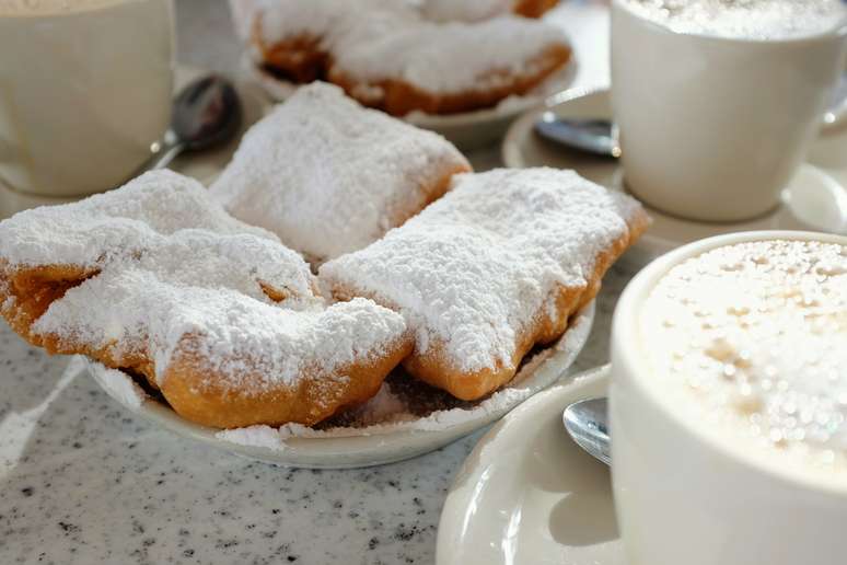 The traditional Café du Monde combination: cream puffs and coffee with chicory and milk The traditional Café du Monde combination: cream puffs and coffee with chicory and milk
