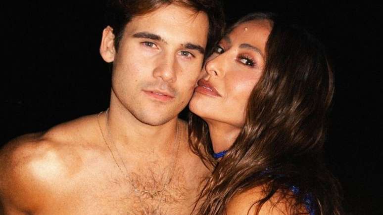 Sabrina Sato and Nicolas Prattes exchange caresses under a waterfall