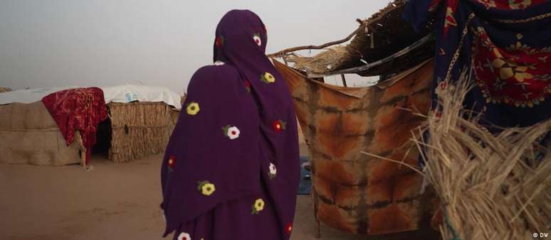 Mulher caminha por acampamento de refugiados sudaneses na República do Chade, norte da África: violência sexual obriga mulheres e crianças a fugir