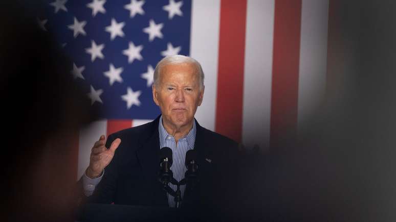 Joe Biden com bandeira dos EUA ao fundo