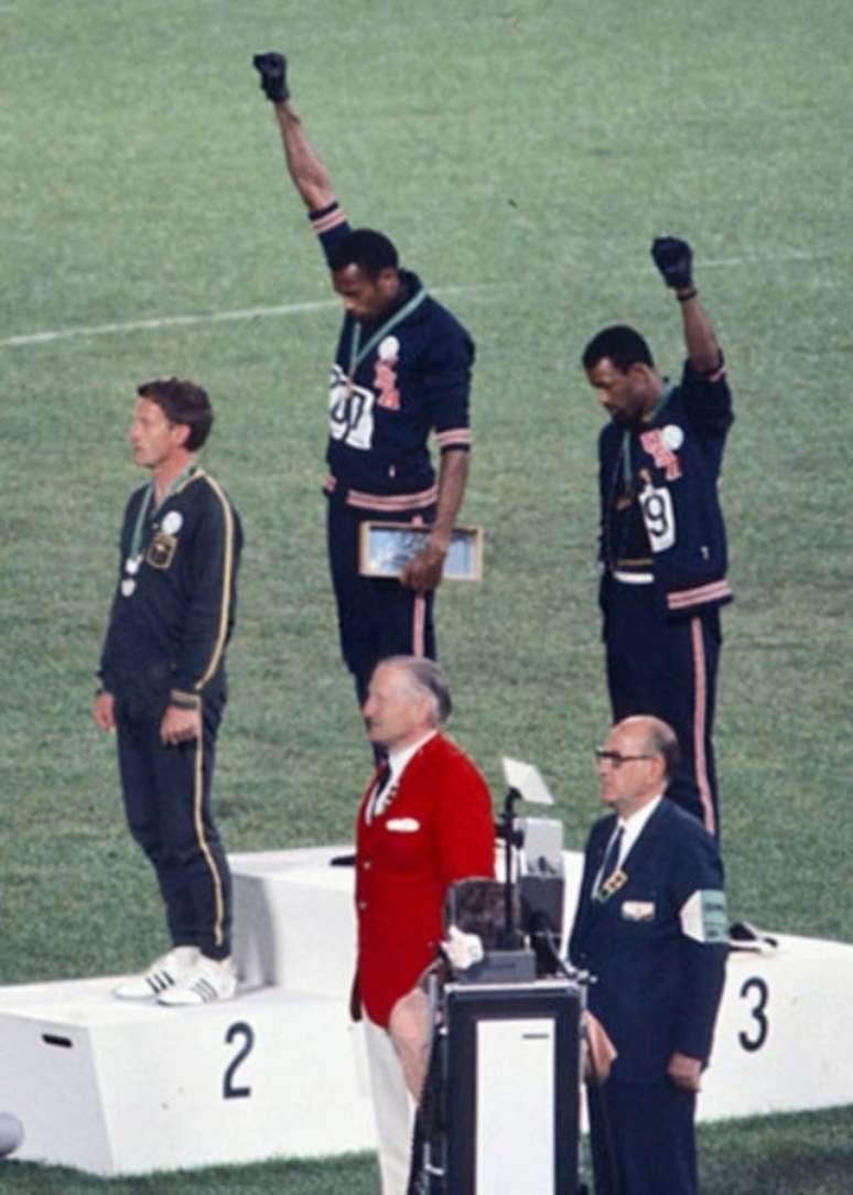 Em ato político, os atletas Tommie Smith e John Carlos celebram a saudação dos Panteras Negras nas Olimpíadas de 1968