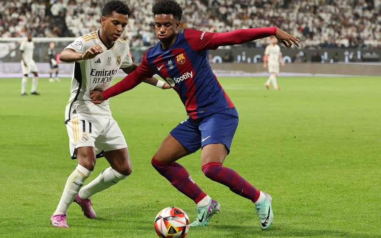 Real Madrid's Brazilian forward #11 Rodrygo and Barcelona's Spanish defender #03 Alejandro Balde vie for the ball during the Spanish Super Cup final football match between Real Madrid and Barcelona at the Al-Awwal Park Stadium in Riyadh, on January 14, 2024.