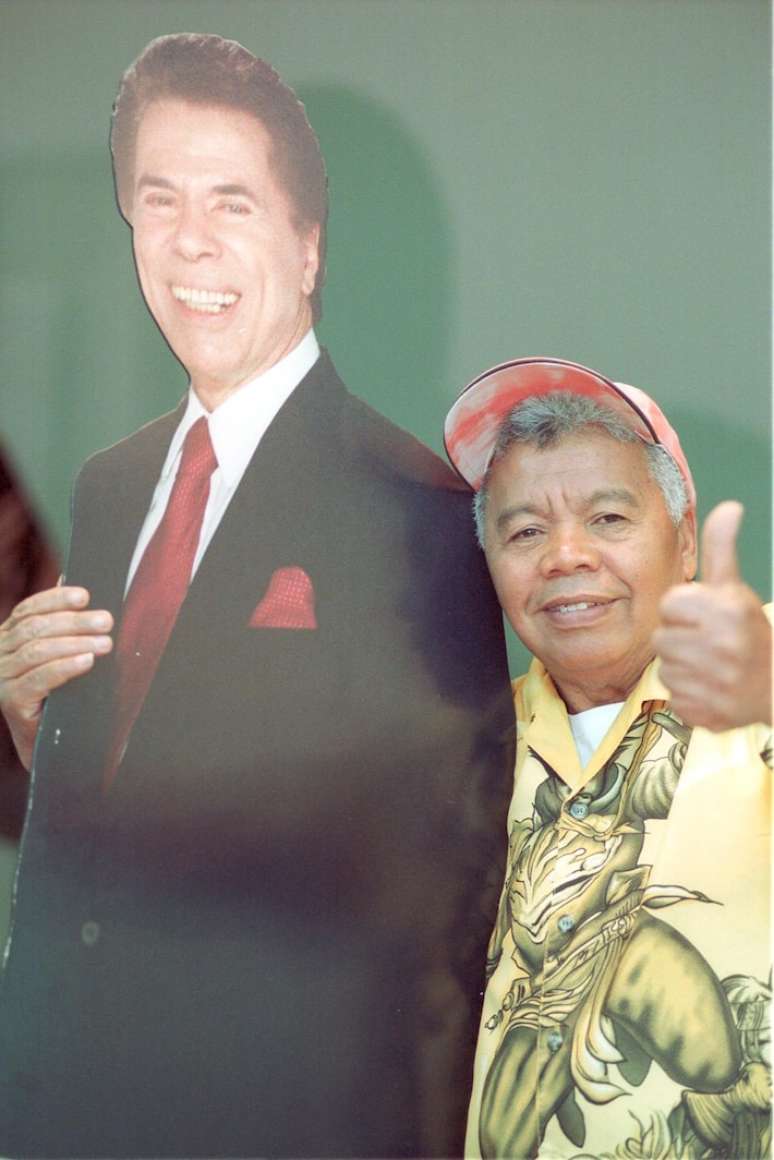 Roque ao lado de 'Silvio Santos' feito de papelão no SBT, em foto de novembro de 2002