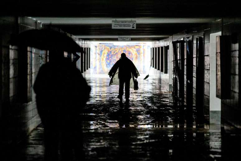 People walk through a flooded tunnel after heavy rains in Moldova.