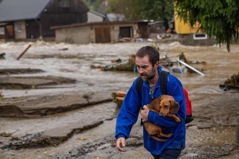 Resident who had to leave his home in Republica Tecca holds his dog