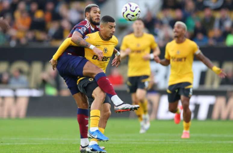 Photo by Carl Recine/Getty Images) - Legenda: André (de amarelo) luta pela bola no jogo em que seu time perdeu de virada para o Newcastle