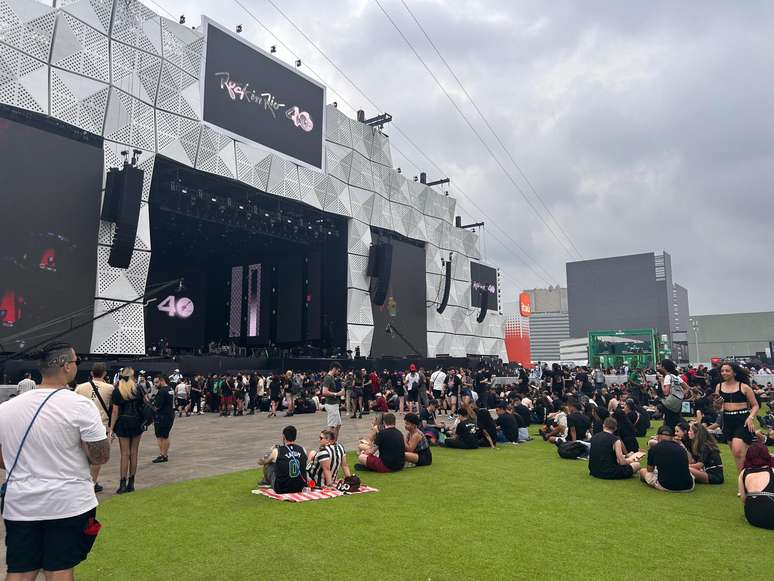 Fãs sentados no gramado da Cidade do Rock