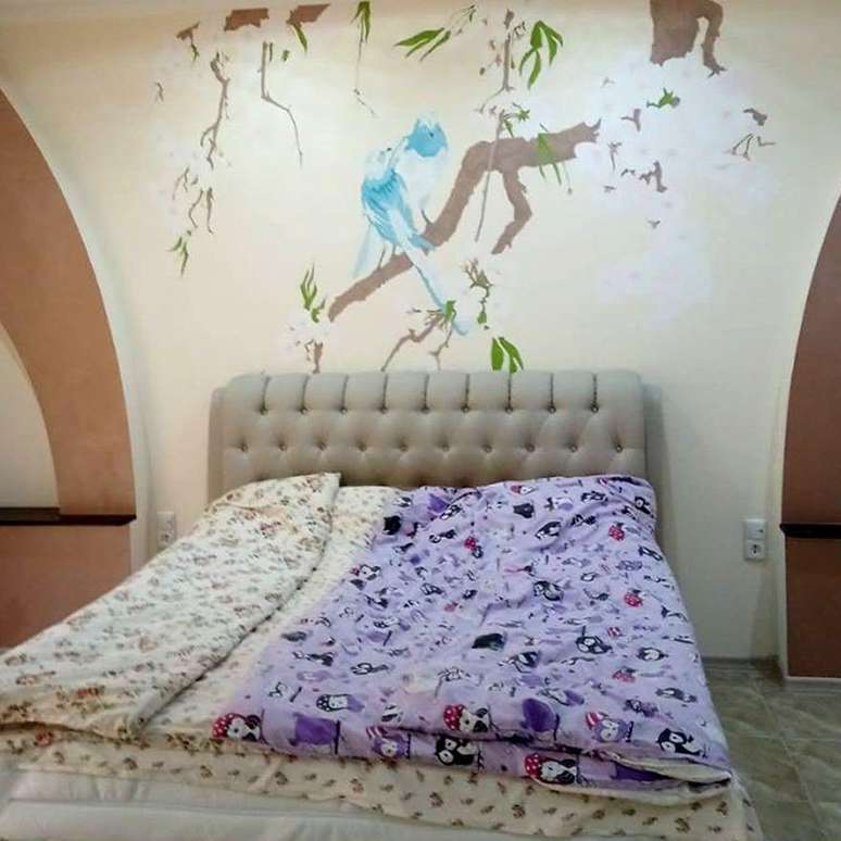 O cômodo preferido de Marina era o quarto, com uma pintura de pombos e flores de cerejeira na parede da cabeceira da cama