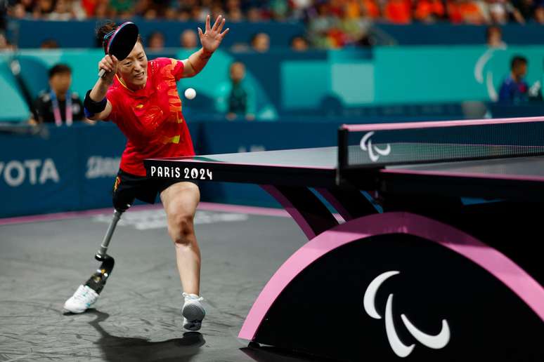 O chinês Wang Rui coloca todo o seu esforço no meio de uma partida de tênis de mesa em Paris 2024